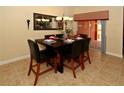 Elegant dining room with a stylish table setting and view to the patio at 8984 Cuban Palm Rd, Kissimmee, FL 34747