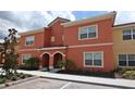 Beautiful condo featuring a modern design, well-maintained landscaping, and a welcoming facade at 8984 Cuban Palm Rd, Kissimmee, FL 34747