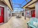 This covered outdoor patio includes an outdoor dining area and comfortable seating at 901 Shorehaven Dr, Poinciana, FL 34759