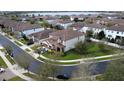 An aerial view of two-story homes with tile roofs, lush lawns, and manicured landscaping at 10902 Citron Oaks Dr, Orlando, FL 32836