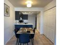 Modern dining area featuring updated tile floors, black cabinets and white trim at 113 Las Brisas Way, Kissimmee, FL 34743