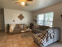 Inviting living room with neutral walls, tile flooring, and a large window offering natural light at 113 Las Brisas Way, Kissimmee, FL 34743