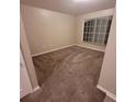 Neutral bedroom with tan carpet and blind covered windows at 119 Southampton Dr, Kissimmee, FL 34744