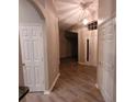 Hallway with wood floor and white doors that add brightness at 119 Southampton Dr, Kissimmee, FL 34744