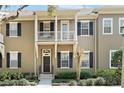 Charming townhome with black shutters, small balconies and landscaped yard at 1343 Flagstone Ave, Celebration, FL 34747