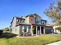 Two-story home with stone accents, charming shutters, with view of pond in background at 1820 Trophy Bass Way, Kissimmee, FL 34746