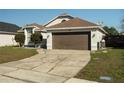 Inviting home exterior with a brown garage door and tidy front lawn at 233 River Chase Dr, Orlando, FL 32807