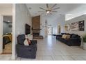 Bright living room with a vaulted ceiling, brick fireplace, and tile floors at 233 River Chase Dr, Orlando, FL 32807