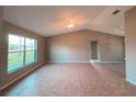 Spacious living room featuring tile flooring, a ceiling fan, and large windows for ample natural light at 2801 Christy Ln, St Cloud, FL 34772