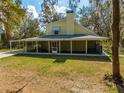 Rear view of a two-story home featuring a full-length screened in porch at 2921 Seminole Rd, St Cloud, FL 34772