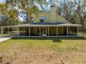 Two-story home featuring an attached carport and a full-length screened in porch at 2921 Seminole Rd, St Cloud, FL 34772