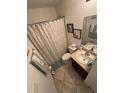 Cozy bathroom featuring a shower with patterned curtain, toilet, and vanity at 299 Chicago W Ave, Haines City, FL 33844