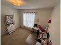 Bright bedroom with natural light, neutral carpet, and a functional workspace at 299 Chicago W Ave, Haines City, FL 33844