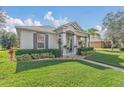 Landscaped front yard featuring lush lawn and decorative shrubs around a well-maintained home at 3050 Grasmere View Pkwy, Kissimmee, FL 34746