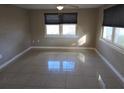 Bright living room with tile floors and lots of natural light from the large windows at 306 W Palm St, Davenport, FL 33837