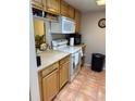 A well-maintained kitchen featuring a white oven, a microwave and warm-toned cabinetry at 3240 S Semoran Blvd # 14, Orlando, FL 32822