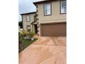 Charming two-story home with a well-manicured front lawn and a spacious driveway at 350 Corsica Ct, Kissimmee, FL 34758