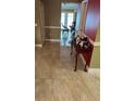 Foyer with decorative table, light-colored tile, and view of double doors leading to another room at 350 Corsica Ct, Kissimmee, FL 34758