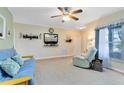 Bright living room featuring neutral walls, carpet flooring, ceiling fan and a large window at 3741 Crossing Creek Blvd, St Cloud, FL 34772