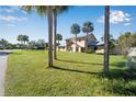 Lovely home with mature palm trees and an expansive front yard with green grass at 4500 Lake Trudy Dr, St Cloud, FL 34769