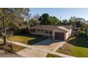 Aerial view of a cozy home with mature trees, fenced backyard, and driveway at 5445 Marvell Ave, Orlando, FL 32839