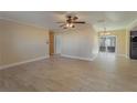 Spacious living room featuring tile floors, ceiling fan, and sliding glass doors to the lanai at 5445 Marvell Ave, Orlando, FL 32839