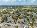 An aerial view of condo community with mature trees and ample parking, nearby homes, and green space at 562 Flemming Way # 200, Maitland, FL 32751