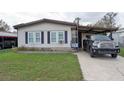 Exterior of home featuring mature lawn and driveway with ample parking at 6332 Bayberry Ne Blvd, Winter Haven, FL 33881