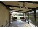 Enclosed sunroom with ceiling fans, providing a relaxing indoor-outdoor space at 6332 Bayberry Ne Blvd, Winter Haven, FL 33881