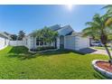 Beautiful single Gathering home with well manicured lawn and mature tropical landscaping at 6410 Cherry Grove Cir, Orlando, FL 32809