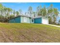 Single-story home has a sprawling lawn, providing a serene and spacious outdoor living environment at 6430 Sw 144Th Street Rd, Ocala, FL 34473