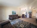 Spacious living room with high ceilings, neutral carpet, and ample seating, perfect for relaxation and entertaining at 790 Greenshank Dr, Haines City, FL 33844