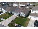 An aerial view of a well-maintained single-Gathering home with lush green lawn at 9009 Pinales Way, Kissimmee, FL 34747