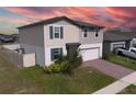 Charming two-story home featuring a two-car garage and beautifully landscaped front yard at 953 Cambridge Dr, Winter Haven, FL 33881