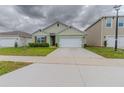 Charming single-Gathering home featuring a two-car garage, manicured lawn, and inviting curb appeal at 1031 August Sky Dr, Deltona, FL 32738