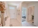 Bright, tiled hallway featuring white walls and an open view of a bedroom at 1031 August Sky Dr, Deltona, FL 32738