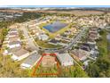 Serene community view with a pond, showcasing the neighborhood and the property within a lush, green environment at 10409 Laxton St, Orlando, FL 32824