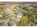 Beautiful aerial view of the neighborhood highlighting the pond, mature trees, and community amenities at 10409 Laxton St, Orlando, FL 32824