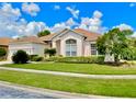 Lovely single-story home with well-maintained landscaping and a two-car garage, under a sunny sky at 106 Southern Pine Way, Davenport, FL 33837