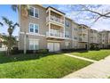 Stylish condo building with white-railed balconies and beautifully manicured landscaping at 1221 Olmstead Blvd # 214, Celebration, FL 34747