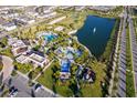 Aerial view showcasing the community pool, playground, and beautiful pond with fountain at 1696 Tropical Palms Cir, Kissimmee, FL 34747