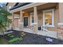 Inviting front porch with stone pillars and landscaping, perfect for relaxing at 1894 Valley Forge Dr, St Cloud, FL 34769
