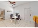 Bright dining room with modern table and chairs, tile floors, and simple decor at 1921 N Forsyth Rd, Orlando, FL 32807