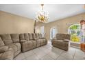 Inviting living room with tile floors, neutral walls, and large windows at 241 Cranbrook Dr, Kissimmee, FL 34758