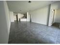 Open living space with tile flooring, recessed lighting, and neutral paint at 250 Brave Rd, Davenport, FL 33837