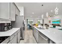 Modern kitchen featuring stainless steel appliances, gray cabinets, large island with sink and bar seating at 2536 Shanti Dr, Kissimmee, FL 34746