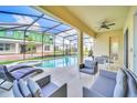 Screened-in pool area with a hot tub, outdoor seating, and view of backyard and neighbor at 2536 Shanti Dr, Kissimmee, FL 34746