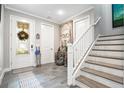 Inviting home foyer features tile flooring, staircase, and decor at 31792 Broadwater Ave, Leesburg, FL 34748