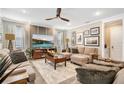 Comfortable living room featuring modern decor, a ceiling fan, and tile floors at 31792 Broadwater Ave, Leesburg, FL 34748