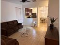 Inviting living room showcasing neutral tile flooring and an open-concept view of the kitchen at 3470 Goldeneye Ln, St Cloud, FL 34772